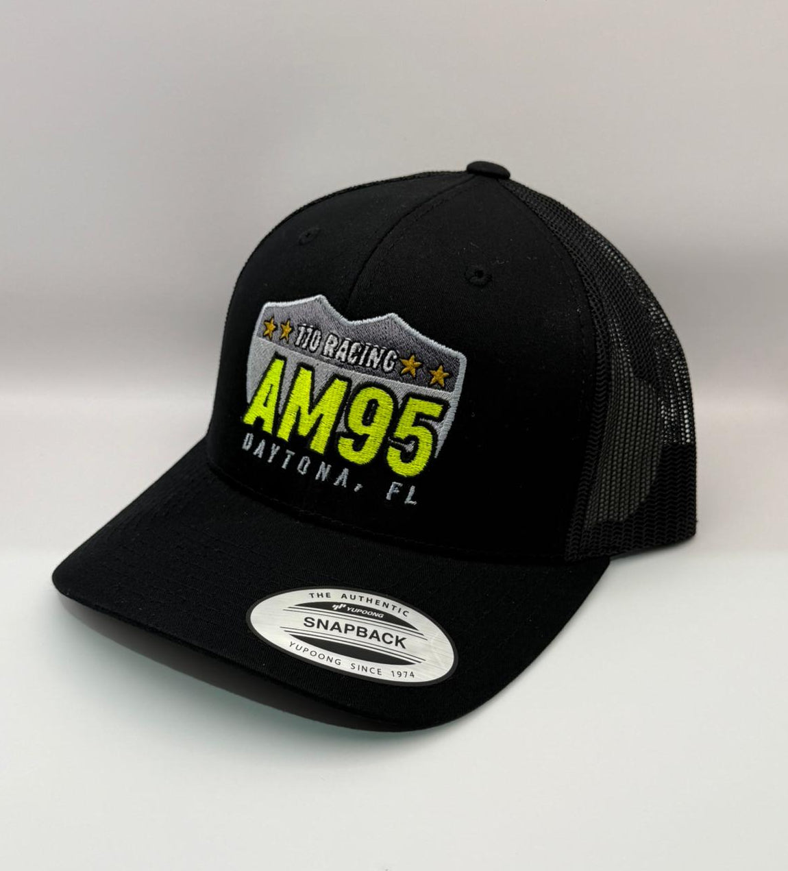 Black trucker cap with AM95 branding on a white background